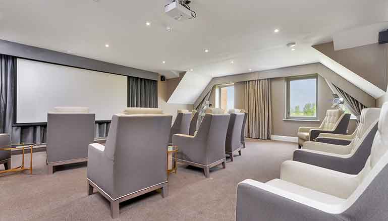 Cinema room with seating and projector screen