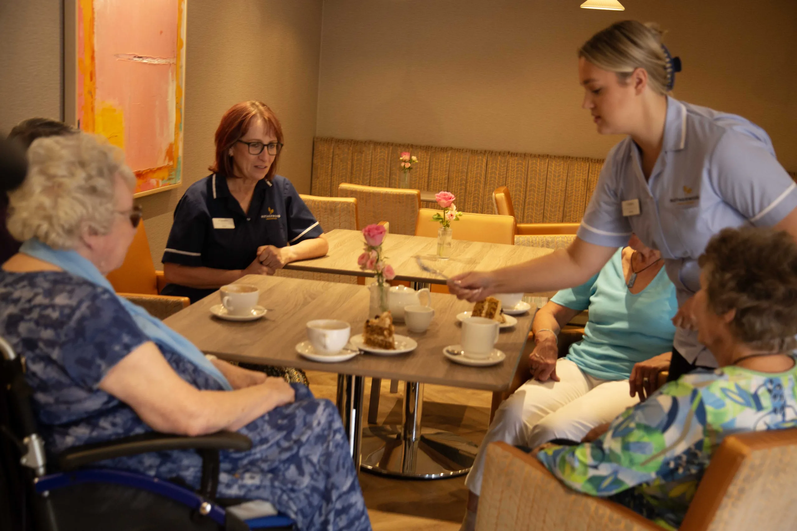 Residents and members of the Colwall team sitting together over tea and cake