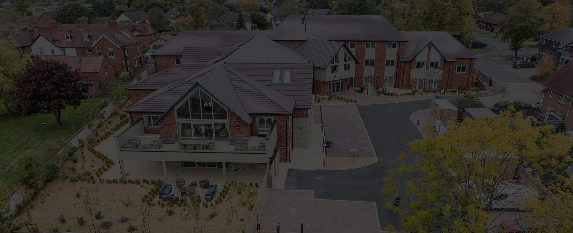 Red brick and green render building 