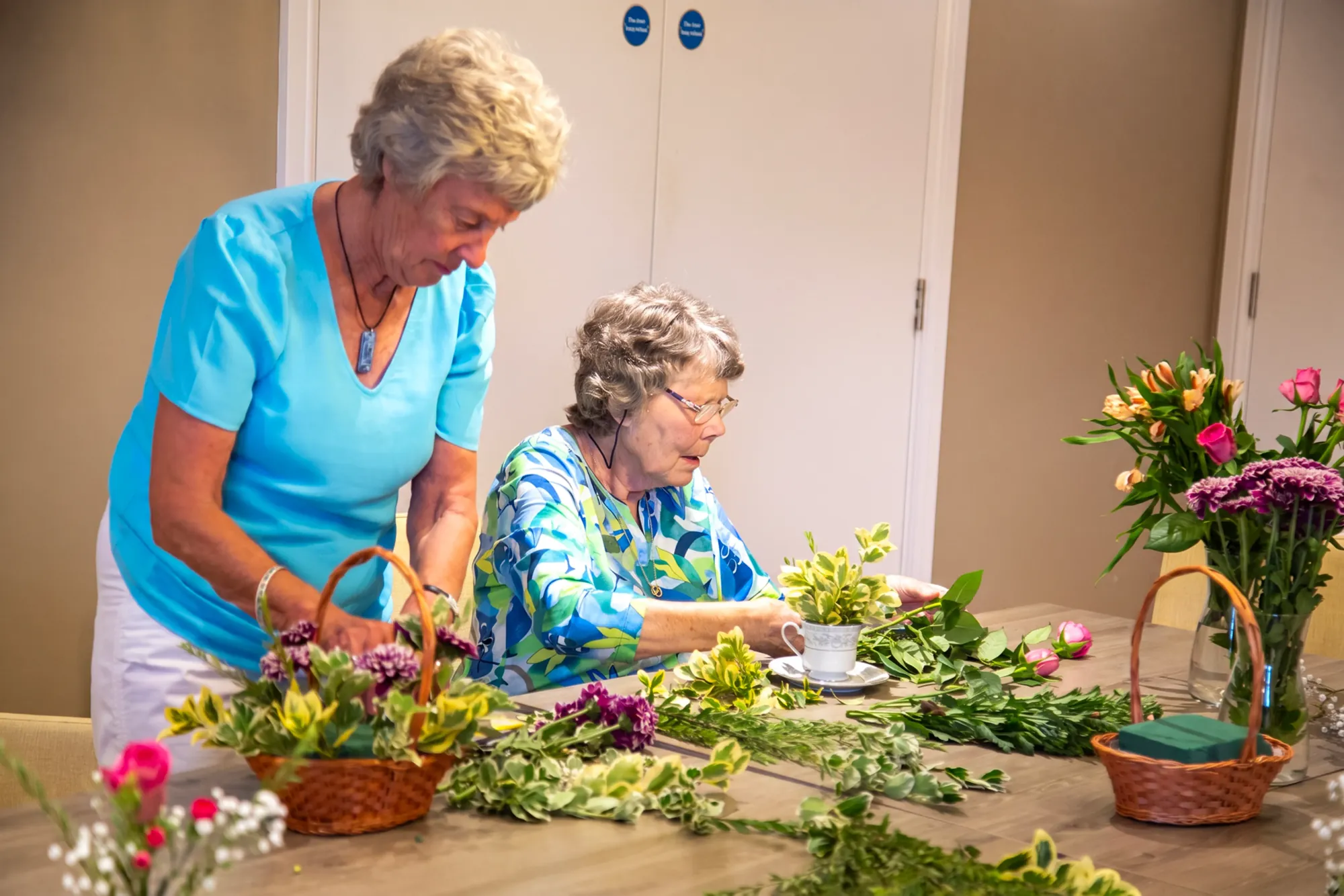 Residents arranging fresh flowers together at Colwall Care Home