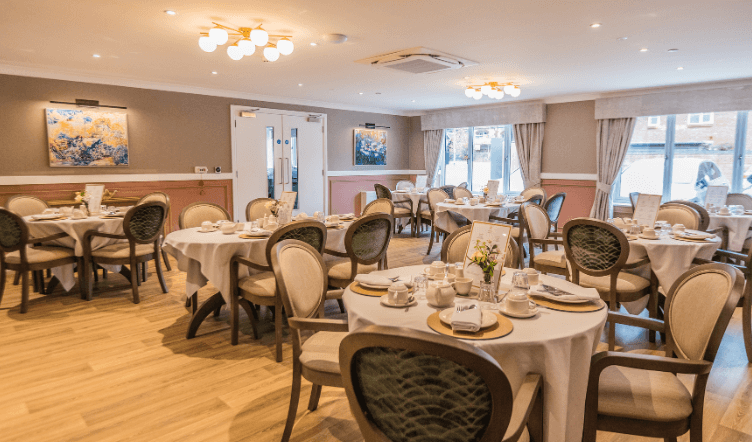 A white plate with a tasty presented meal featuring carrots, peas, and potatoes.