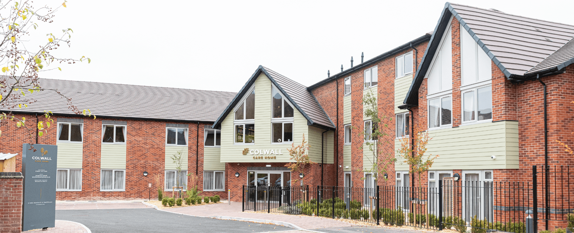 Red brick and green render building 
