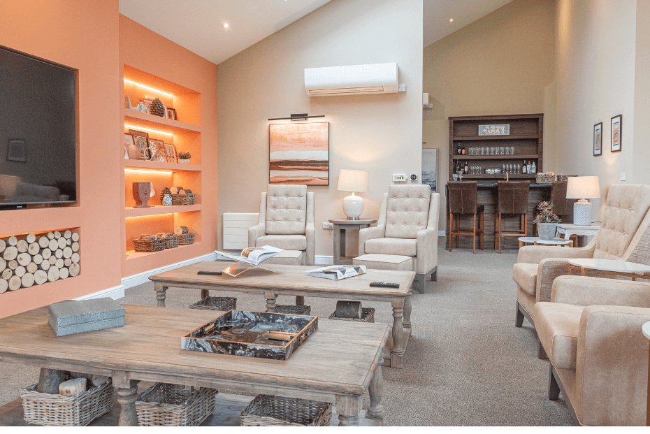 Comfy beige chairs with low coffee table and bar in the background