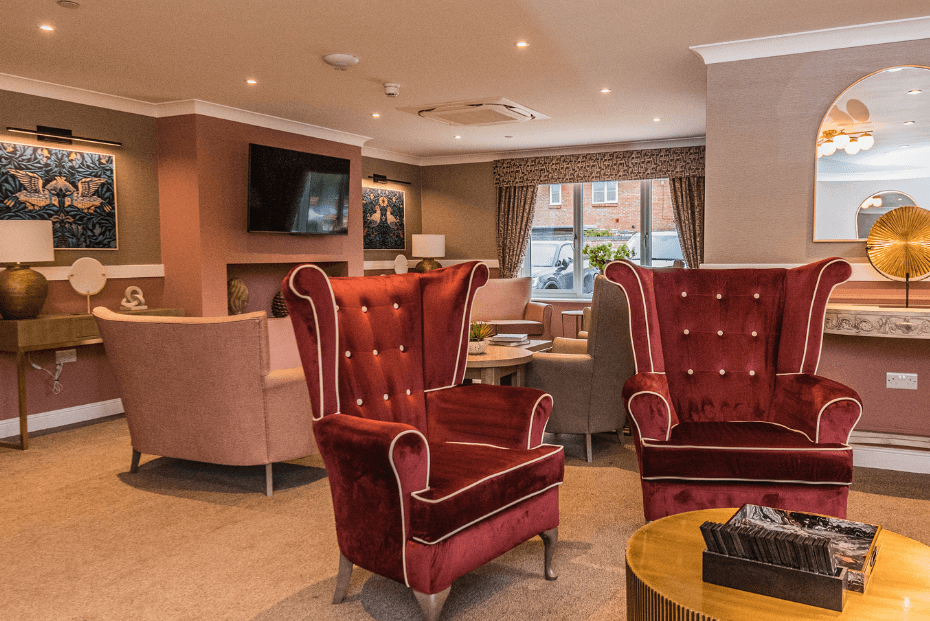 Two large red velvet armchairs in a beautifully decorated living space 