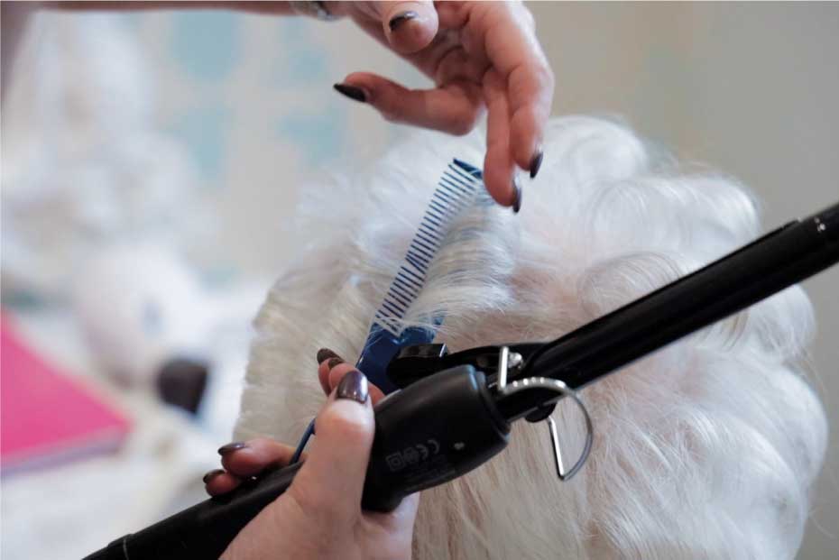 Close up of an elderly ladies hair being trimmed