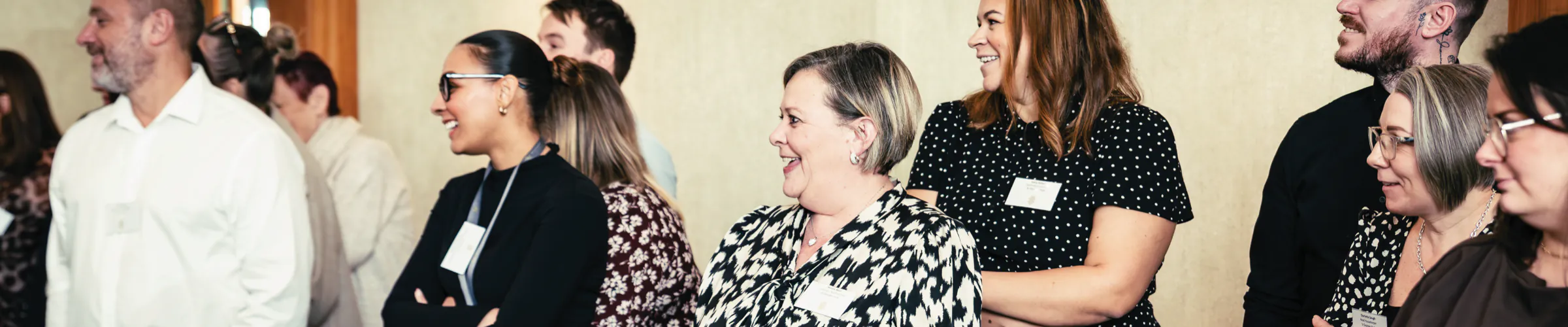 Rotherwood team members smiling and chatting together at a company conference