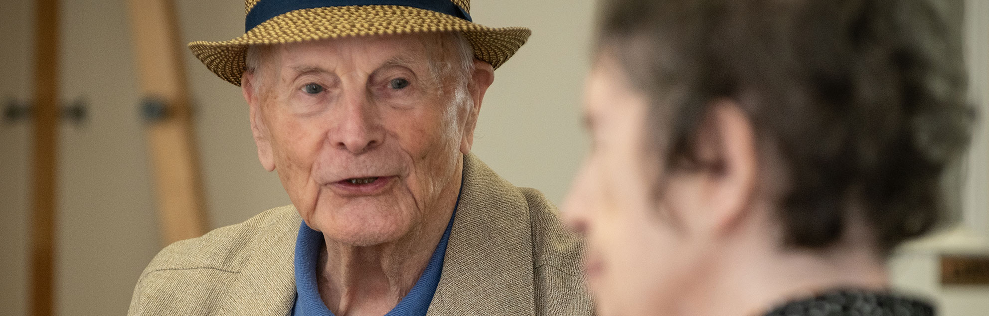 An elderly man and elderly lady in conversation