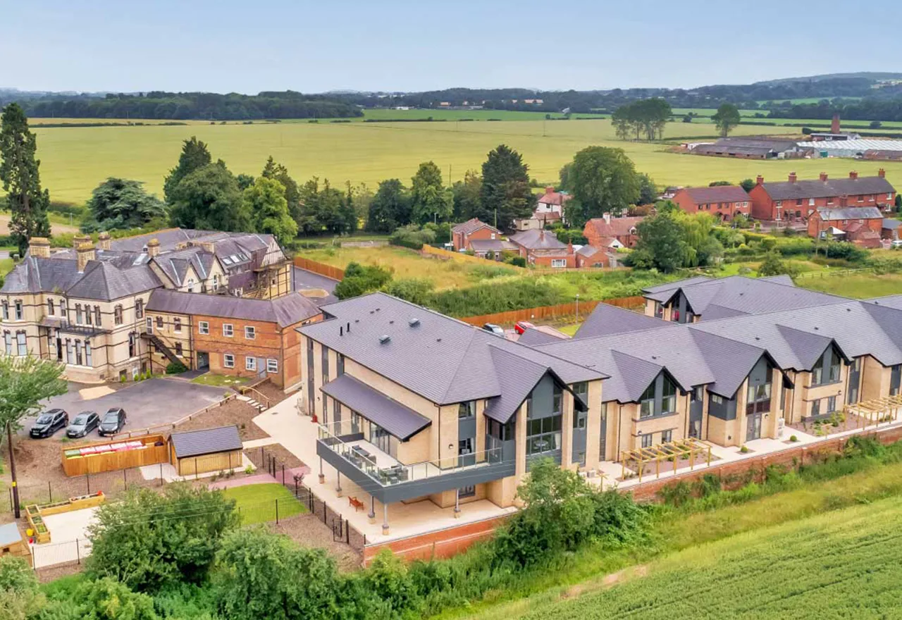 An aerial view of Roden Hall and its modern extension, surrounded by open Shropshire countryside